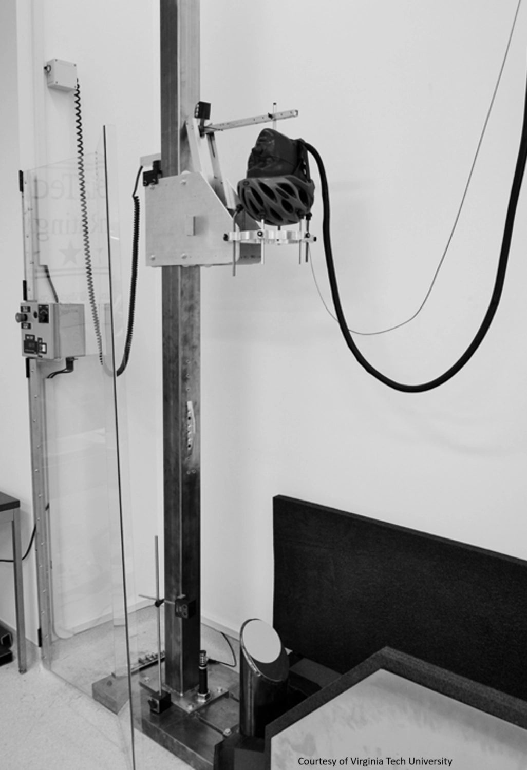 Black and white image of a mechanical helmet drop machine from Virginia Tech University
